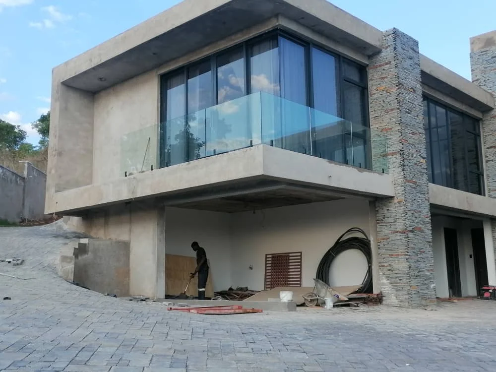 Modern residence with large aluminium glazing and glass balcony balustrade